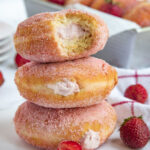 3 Strawberry Cream Filled Doughnuts stacked on top of each other