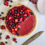 Strawberry and White Chocolate Tart with dessert plates and cutting knife