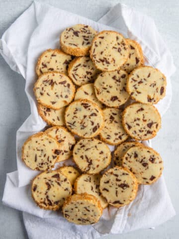 chocolate orange shortbread cookies on tea towel lined plate