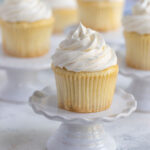 vanilla cupcake on a miniature cake stand