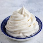 vanilla buttercream swirled into a small blue bowl