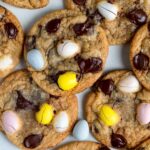 A closeup of Easter chocolate chip cookies arranged on a flat surface. The cookies overlap each other.