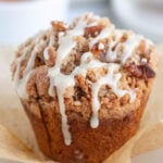 A pumpkin streusel muffin on top of an opened brown wrapper