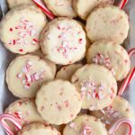 Peppermint shortbread cookies on a shallow plate lined with parchment paper