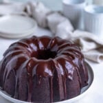 Chocolate sour cream pound cake with a chocolate ganache glaze. The cake is on a white plate