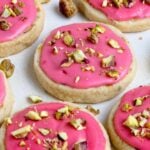 Pistachio shortbread cookies with raspberry glaze and chopped nuts
