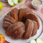 Apple cider bundt cake on a white platter