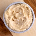 Honey butter in a small ceramic bowl with flaky sea salt sprinkled on top