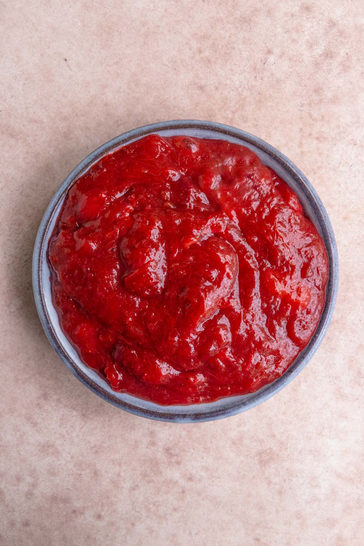 Rhubarb and strawberry pie filling in a blue bowl