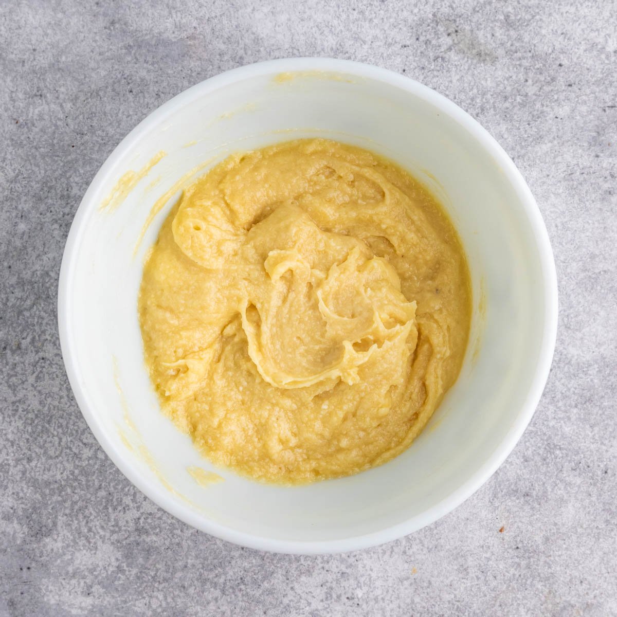 Frangipane almond filling after the almond flour and flour have been added. The mixture appears creamy and is a light yellow