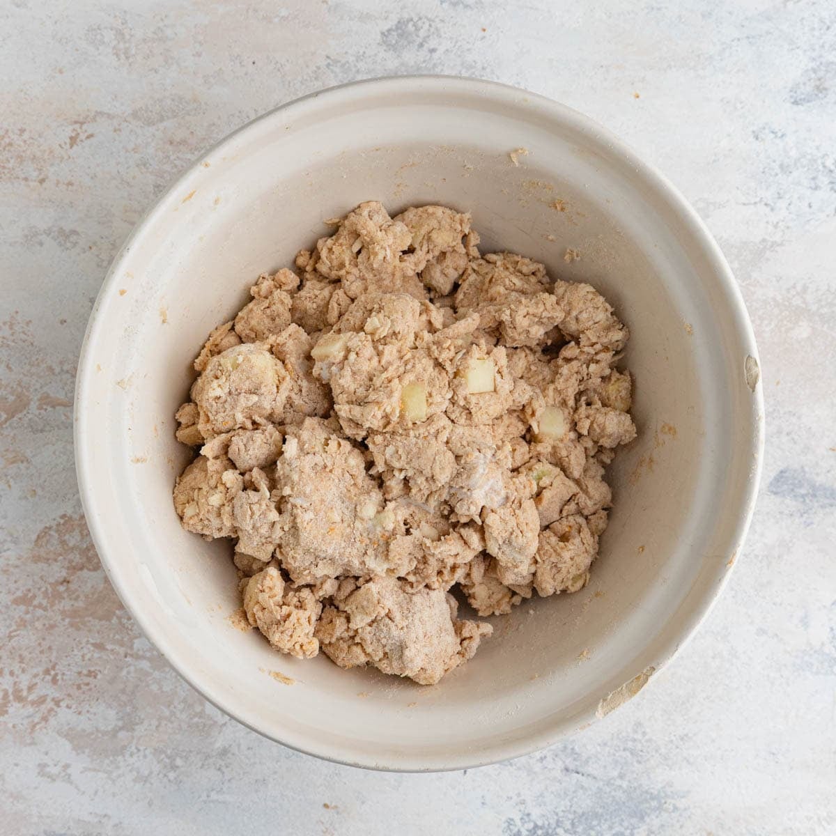 The scone dough after the heavy cream has been mixed in. You can see the chunks of apple.