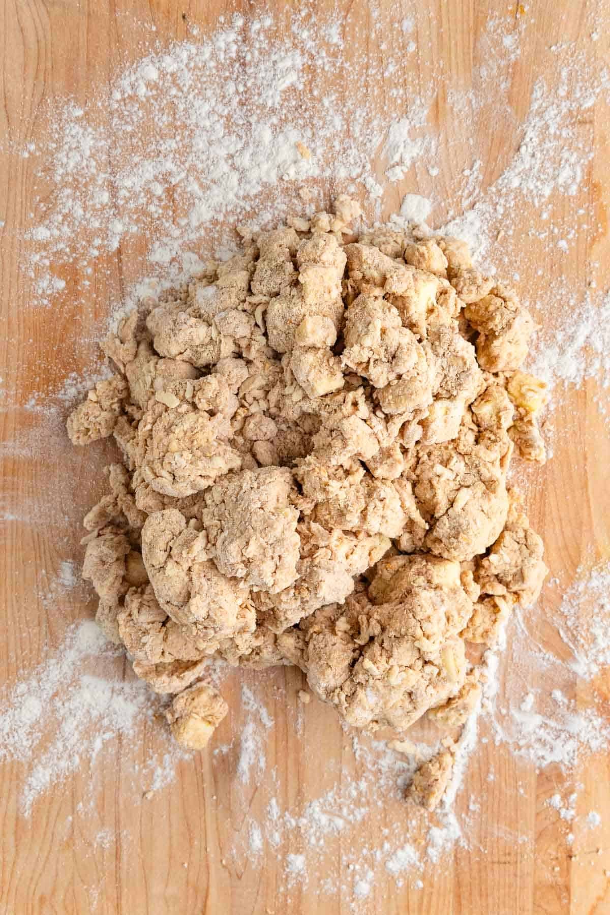 The dough dumped onto a well-floured wooden board.