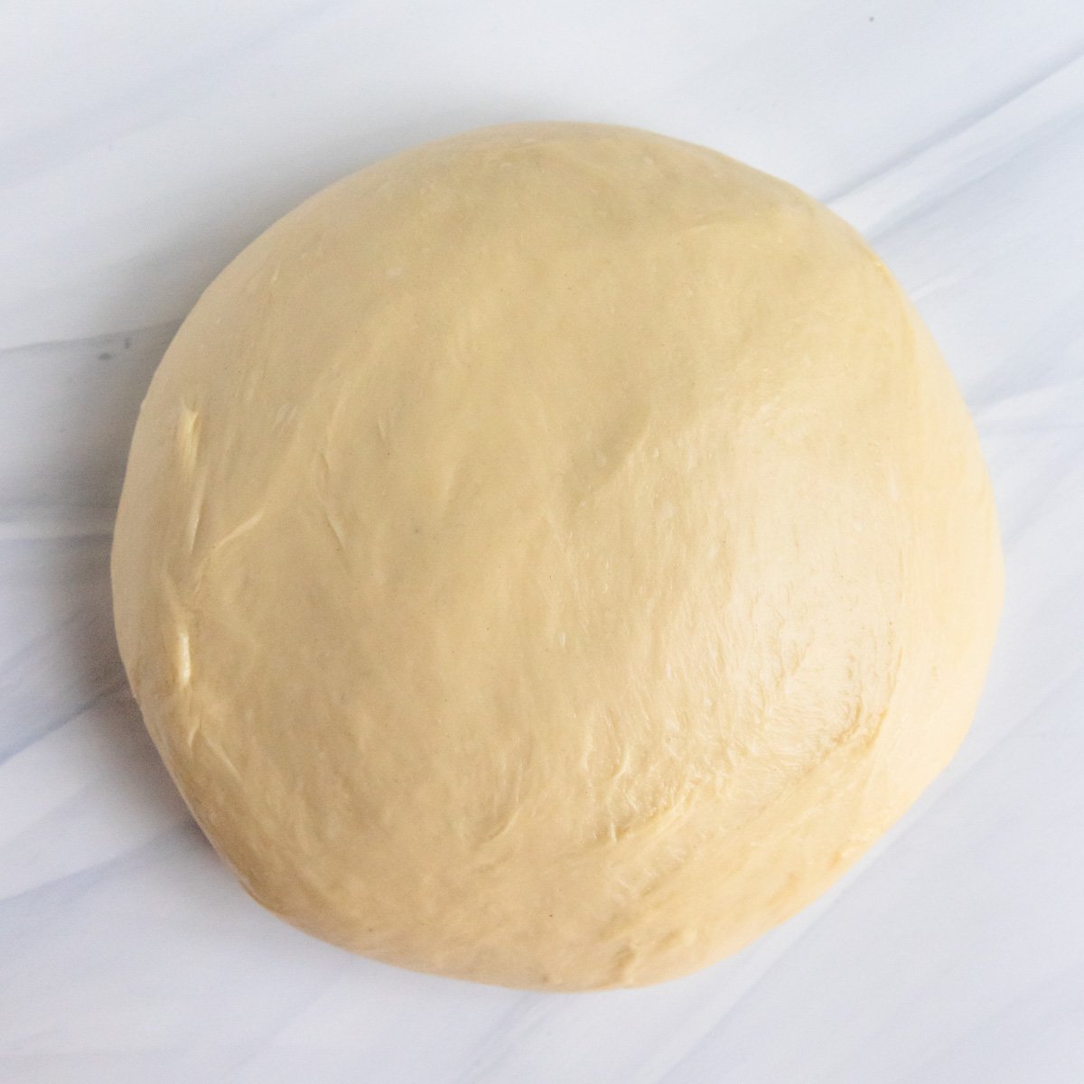 Brioche dough on a cream colored board