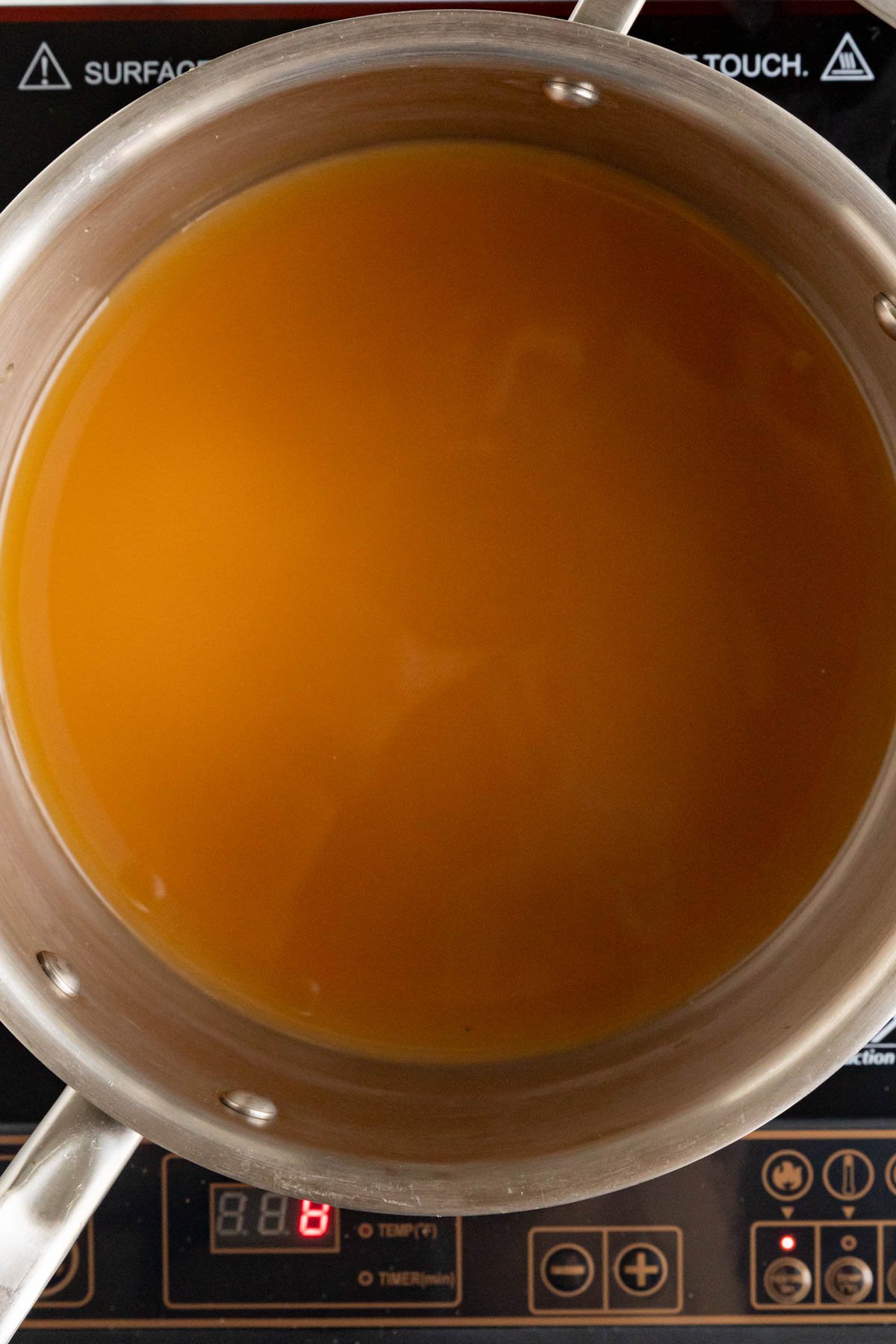 Apple cider in a stainless steel saucepan