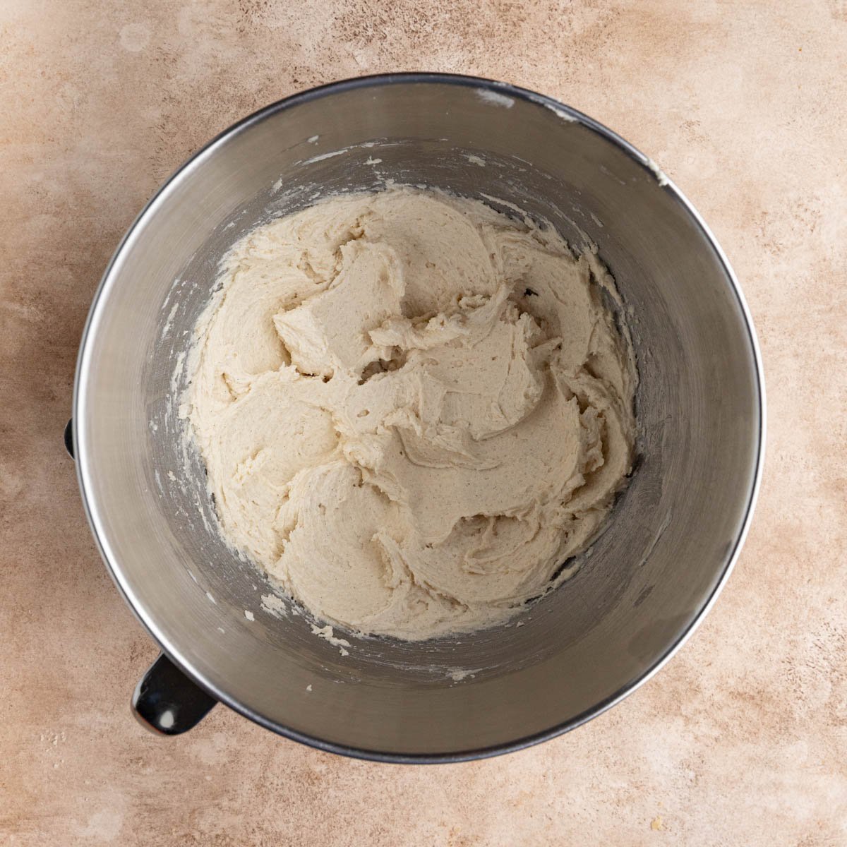 The butter, sugar, and vanilla bean paste creamed together in the bowl of a stand mixer