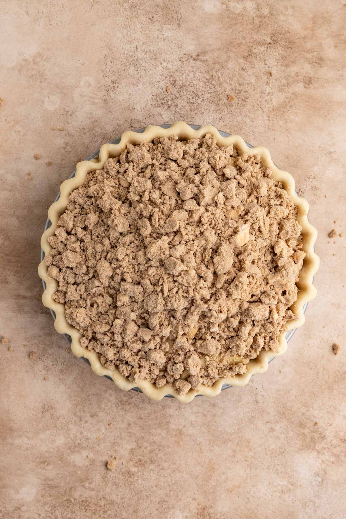 the pie with the apple filling and the brown sugar crumble spread across the top