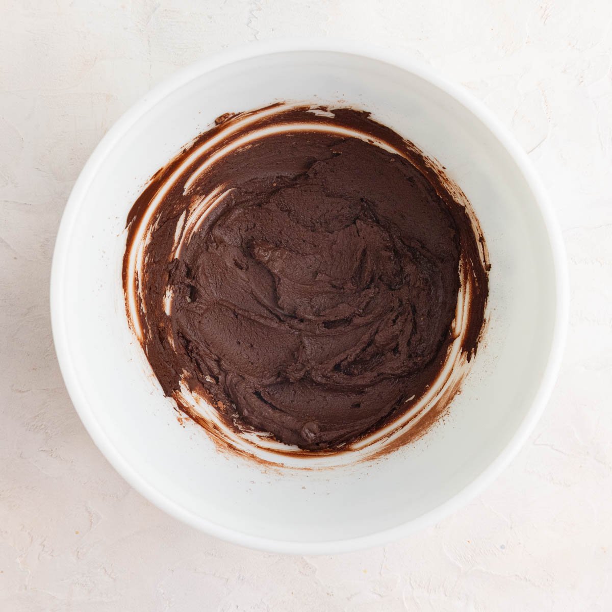  A chocolate paste made of cocoa, instant espresso, and hot water in a white ceramic bowl