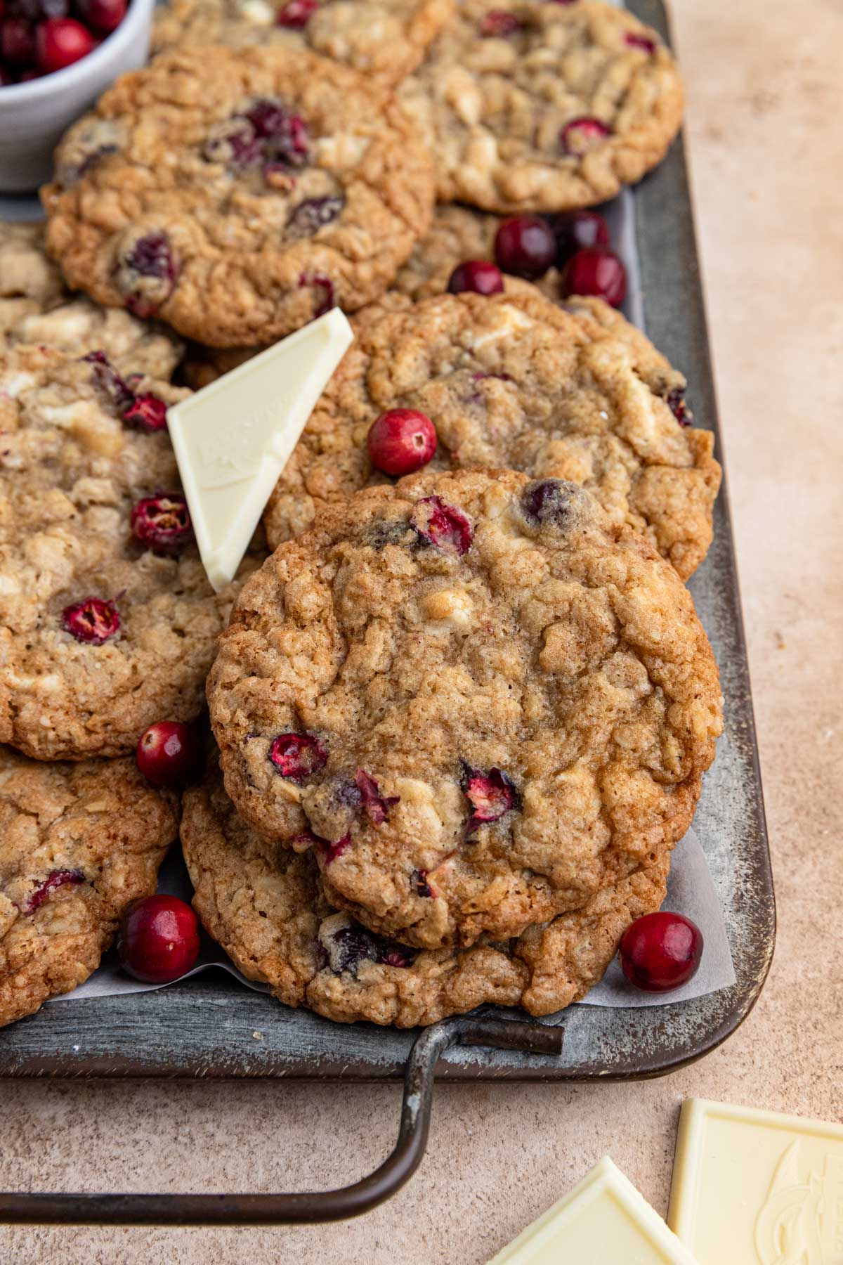 Cranberry white chocolate oatmeal cookies arranged on a dark gray serving tray.