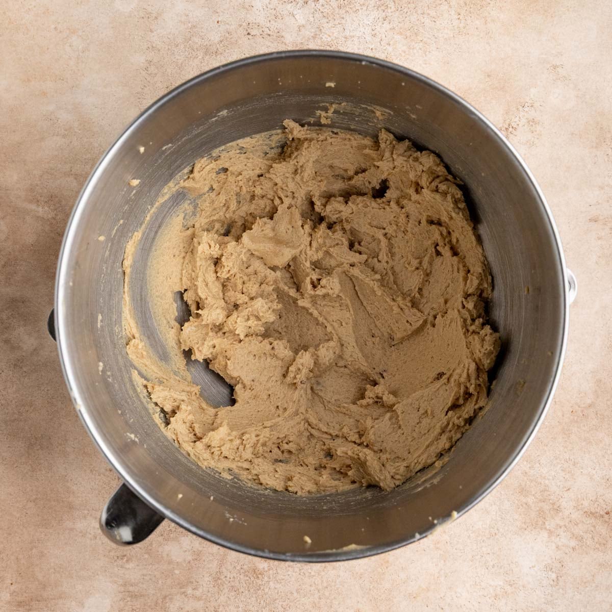 The cookie dough after the eggs are mixed in color. The dough is lighter in color after beating in the eggs.