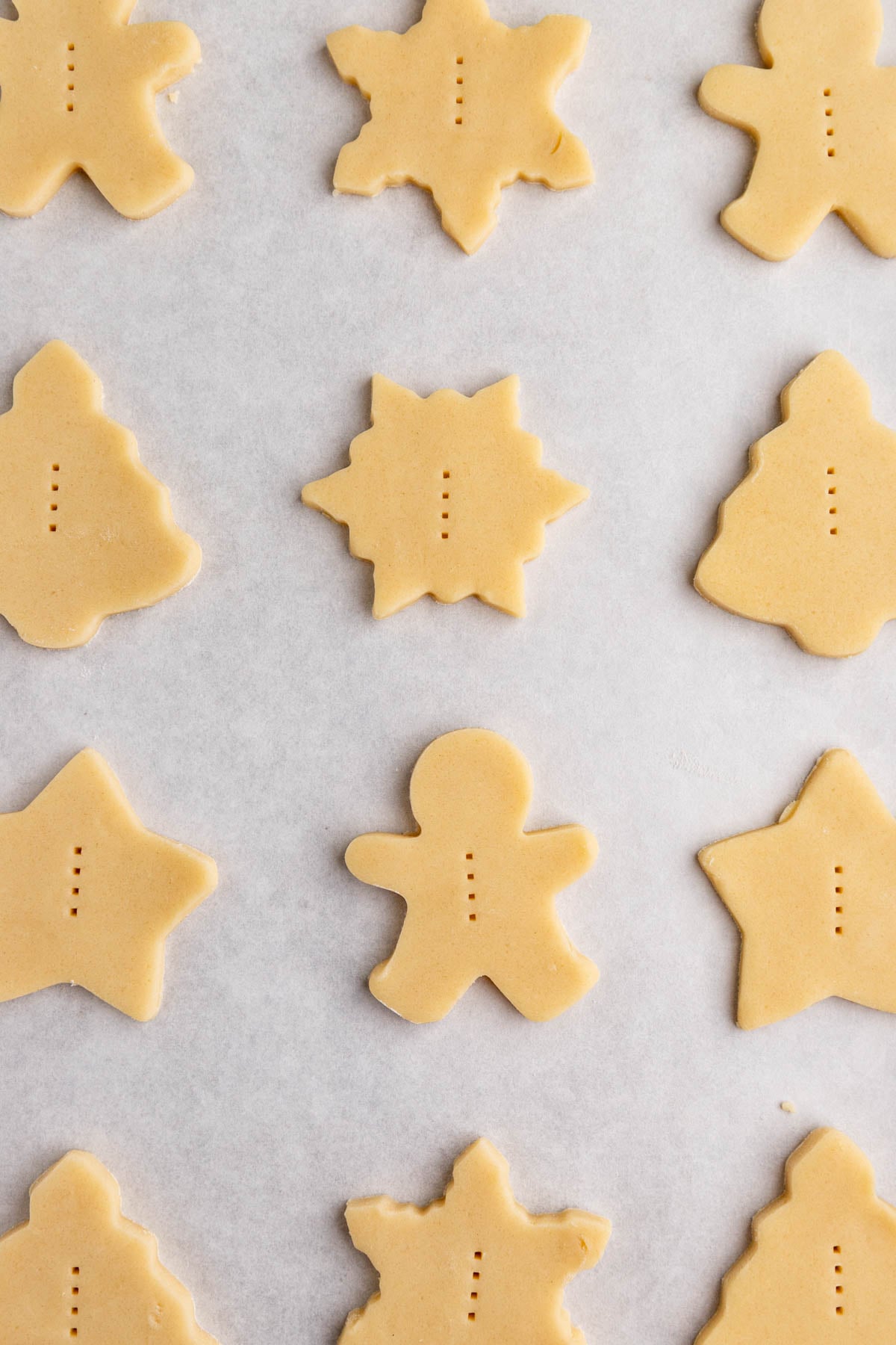 Unbaked shortbread cookies on a parchment lined baking sheet