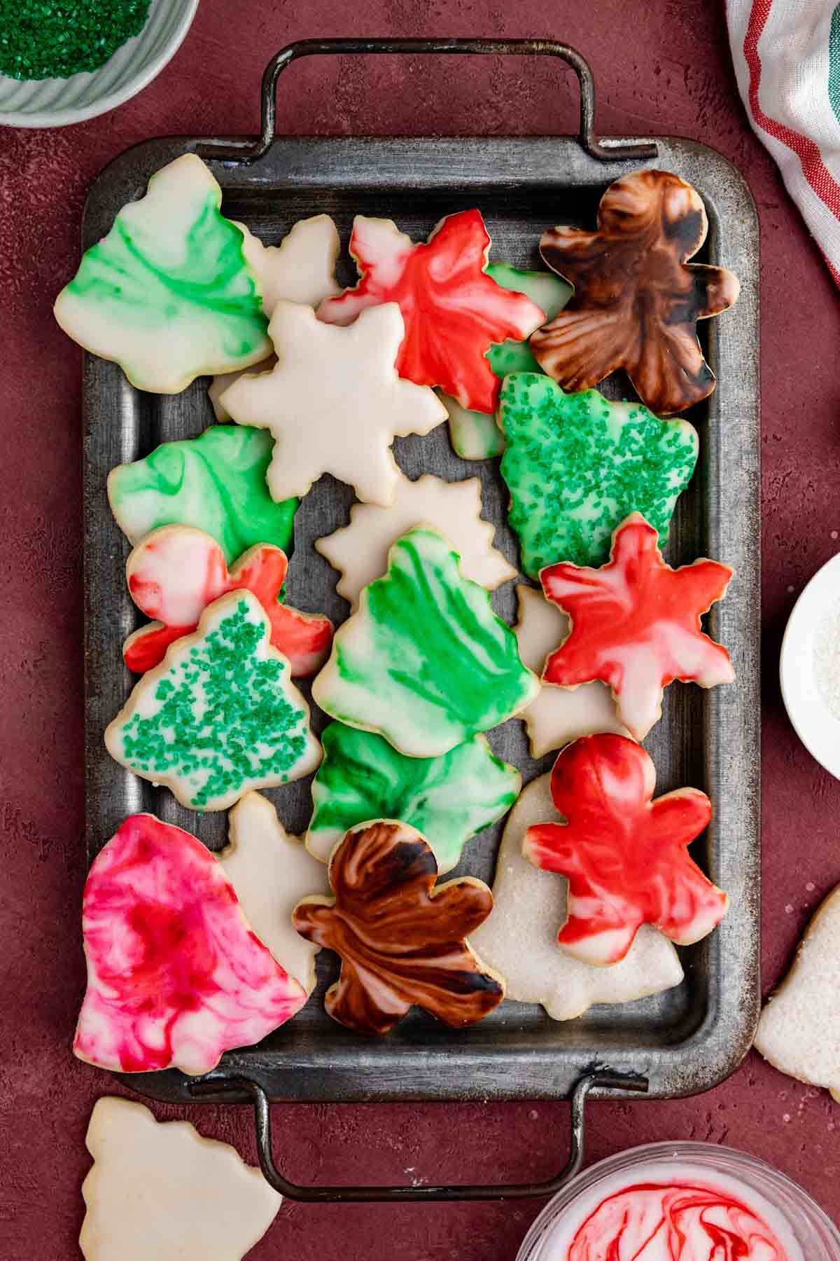 Decorated shortbread cookies on a grey metal platter