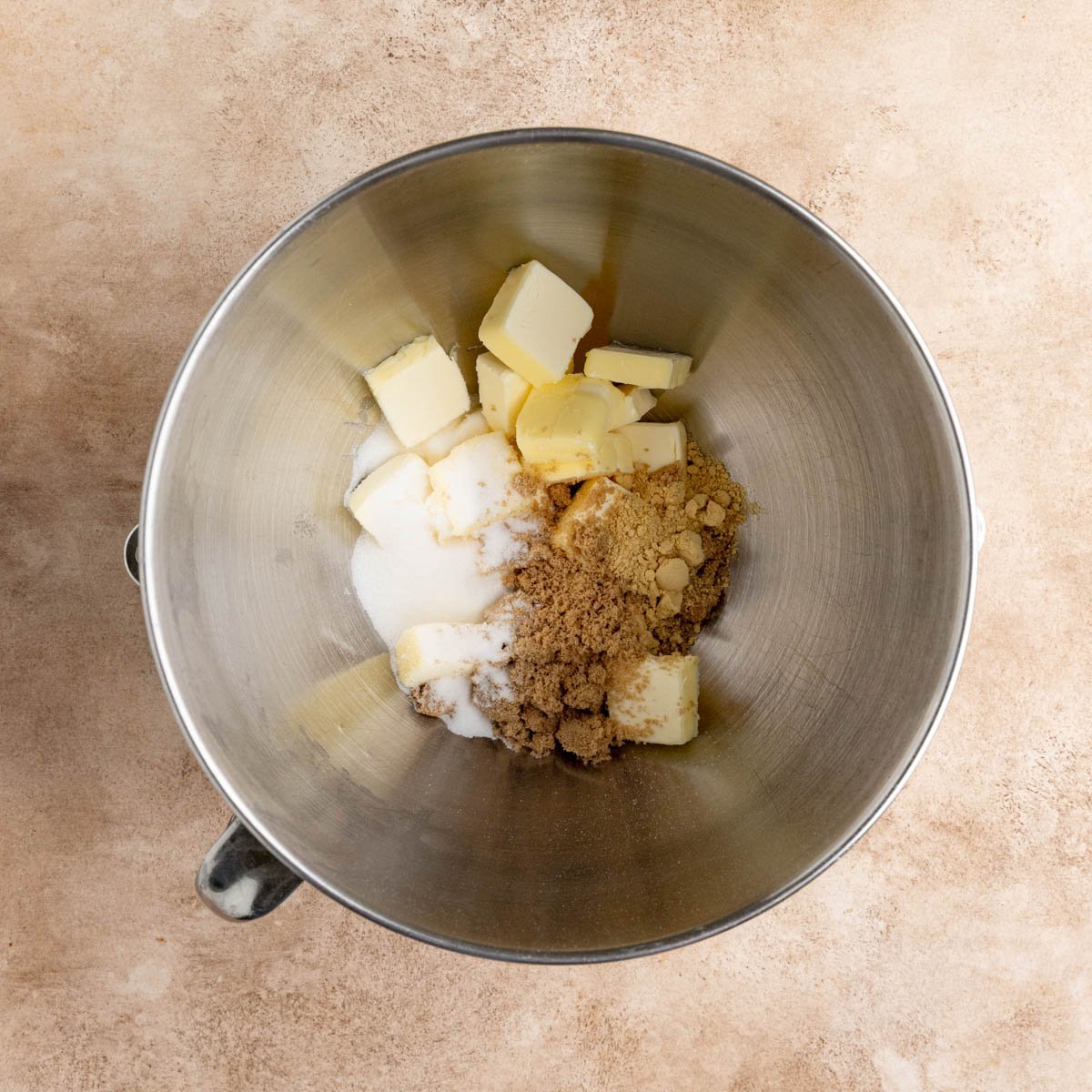 Butter, brown sugar, granulated sugar, ground ginger in the stainless steel bowl of a stand mixer