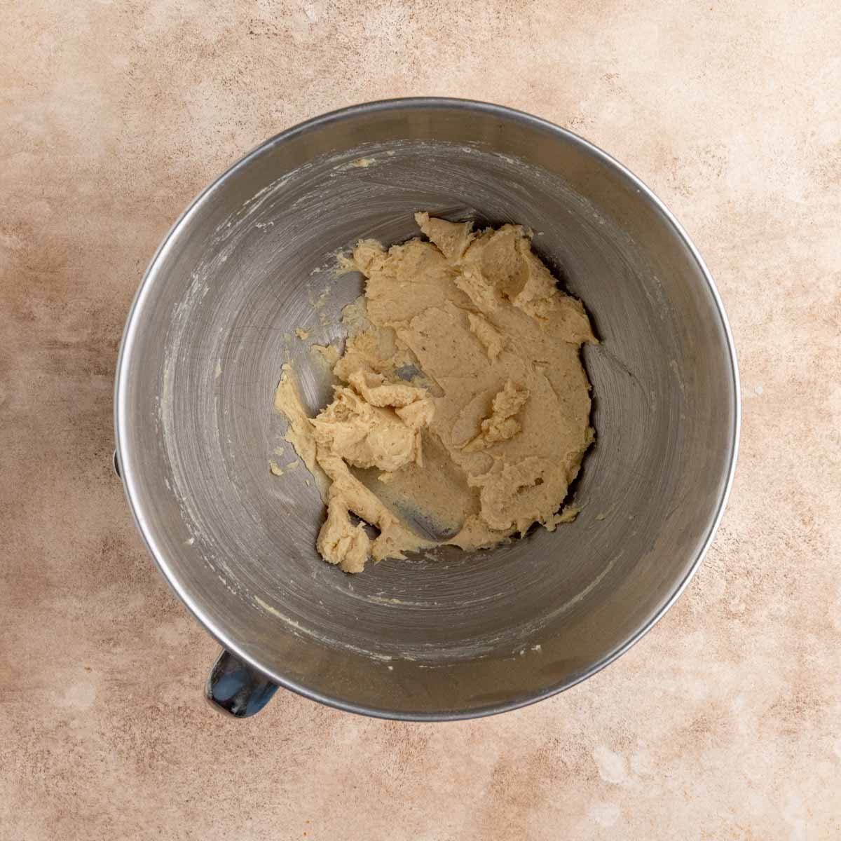 Creamed butter and sugar with ground ginger in the bowl of a stand mixer.