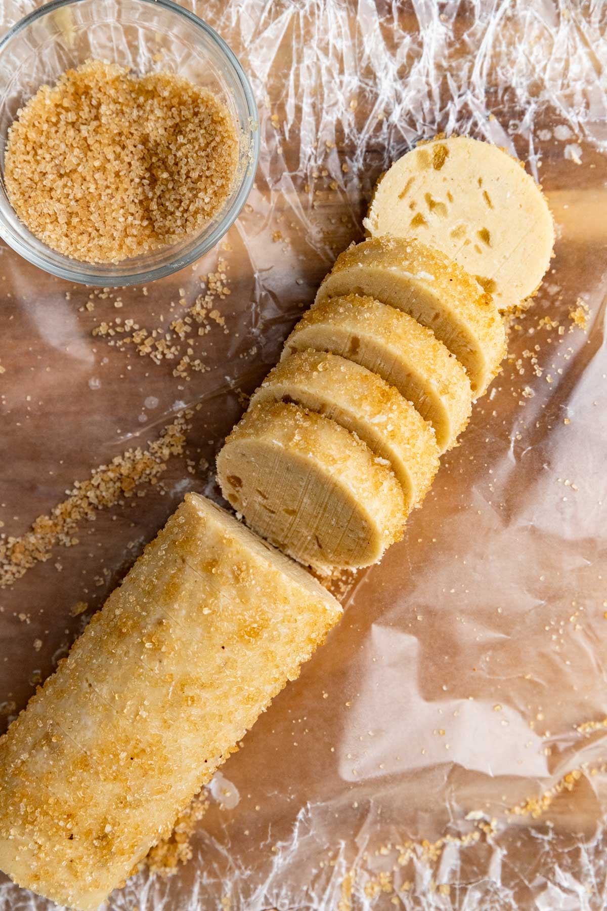 A ginger shortbread cookie dough log coated with turbinado sugar and sliced into 2-inch thick rounds