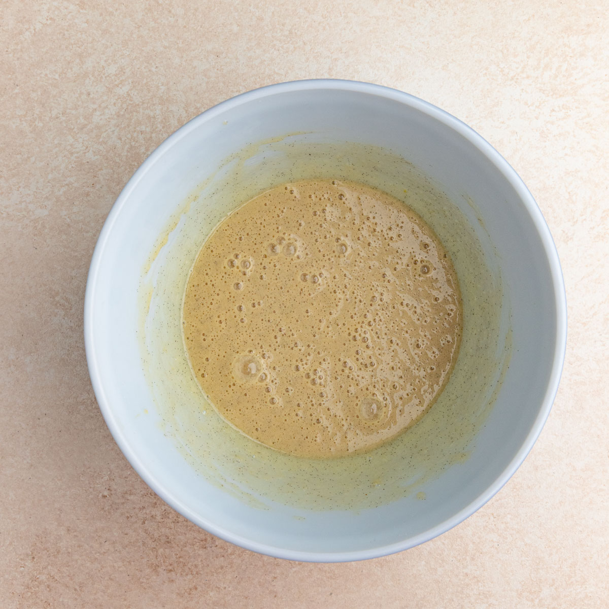 Eggs, sugar, and vanilla bean paste mixed together.  The batter is a light brown