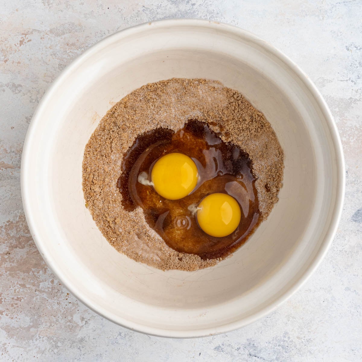 Sugar spice mixture with 2 large eggs in a large mixing bowl