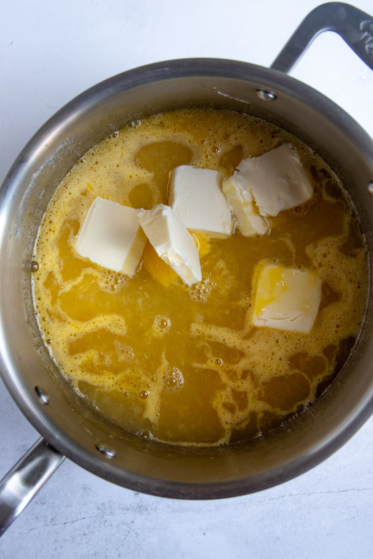 Lemon juice, lemon zest, sugar, butter, eggs, and whole eggs in 4-quart saucepan