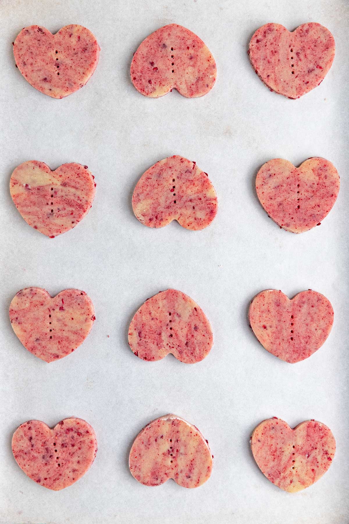 Twelve unbaked cookies on a parchment-lined baking sheet