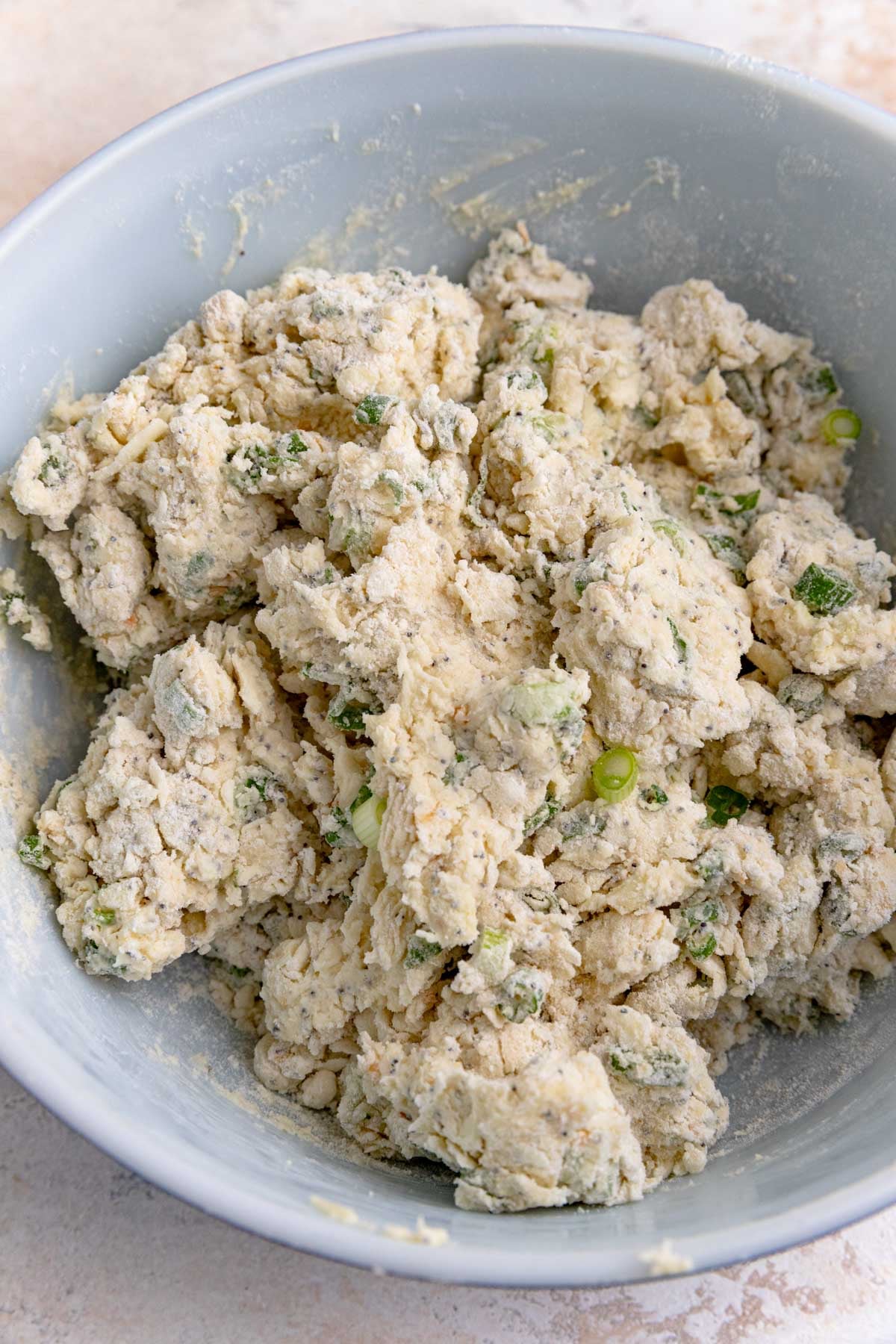 Everything bagel scone dough in a white ceramic bowl