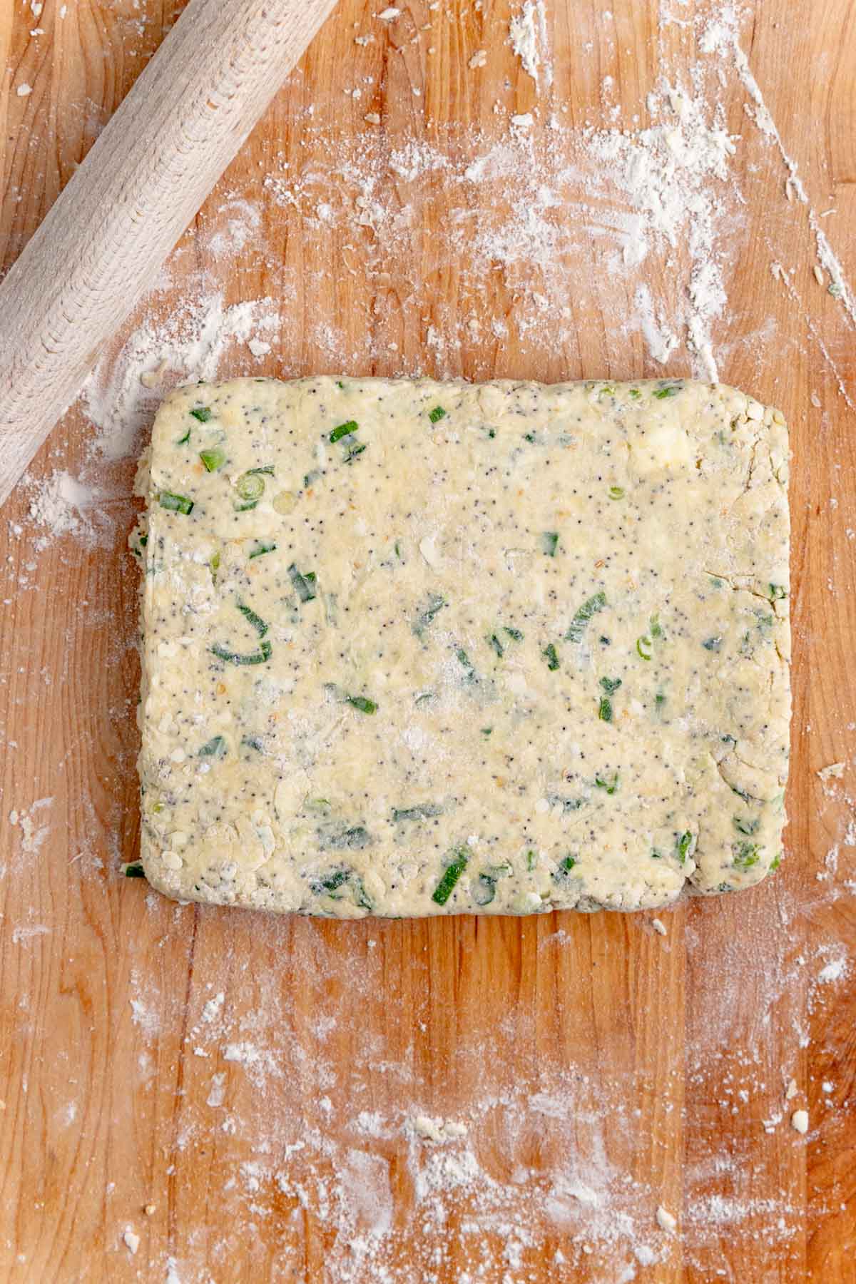 Everything bagel scone dough shaped into a 9x7-inch rectangle