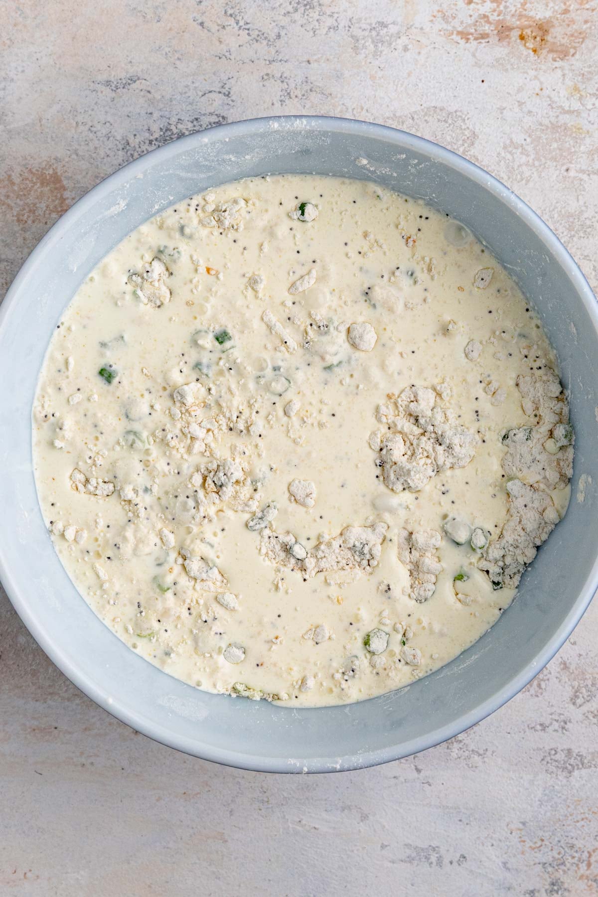 Heavy cream sitting on top of the flour, butter, and green onion mixture.
