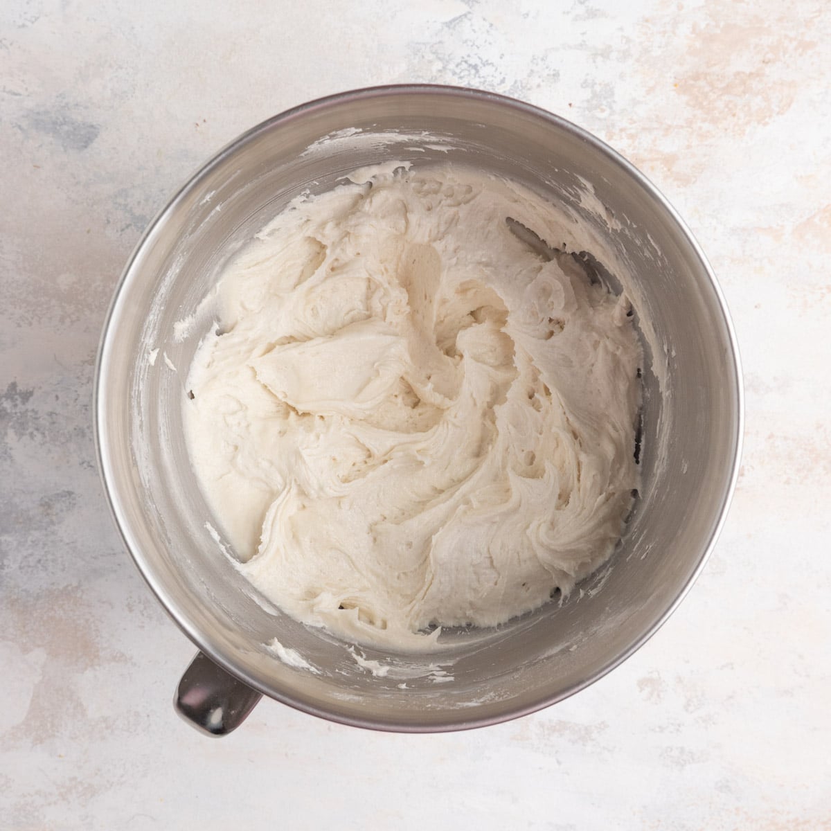 The dry ingredients, butter, and buttermilk mixed together in a mixing bowl. The batter is thick and looks creamy