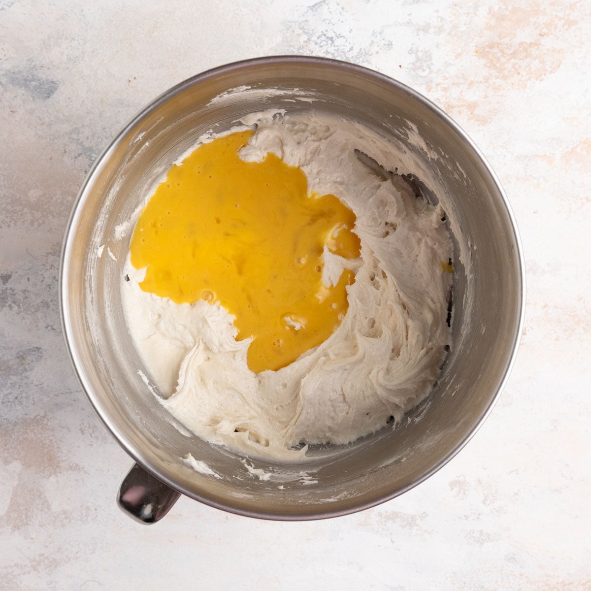 The egg mixture added to the cake batter in the bowl of a stand mixer