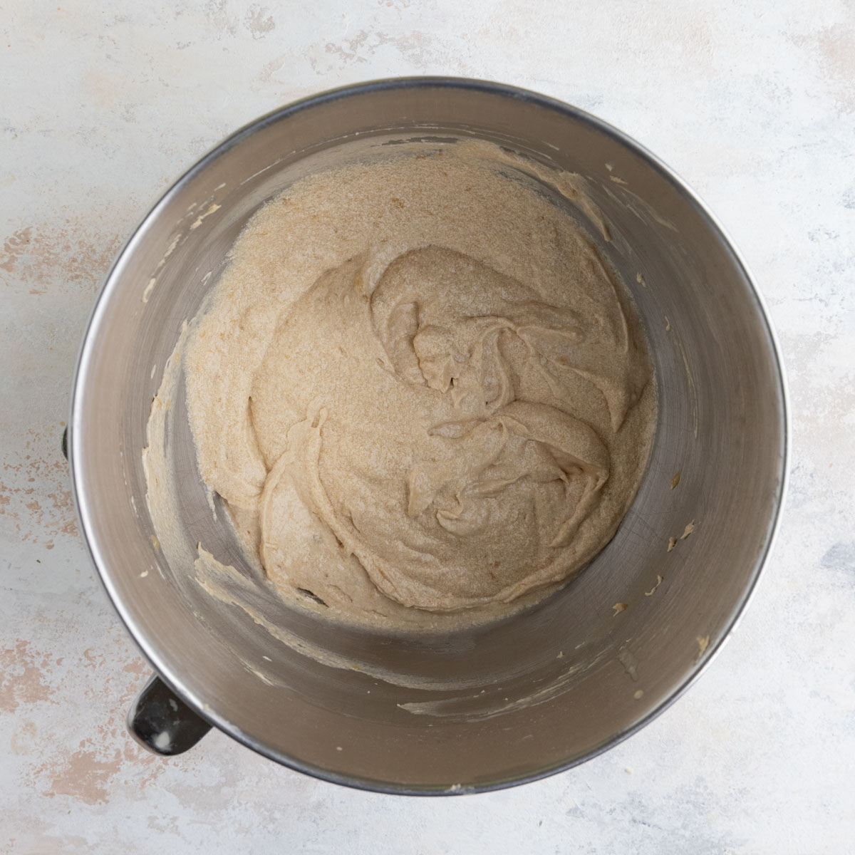 Banana cupcake batter in the stainless steel bowl of a stand mixer