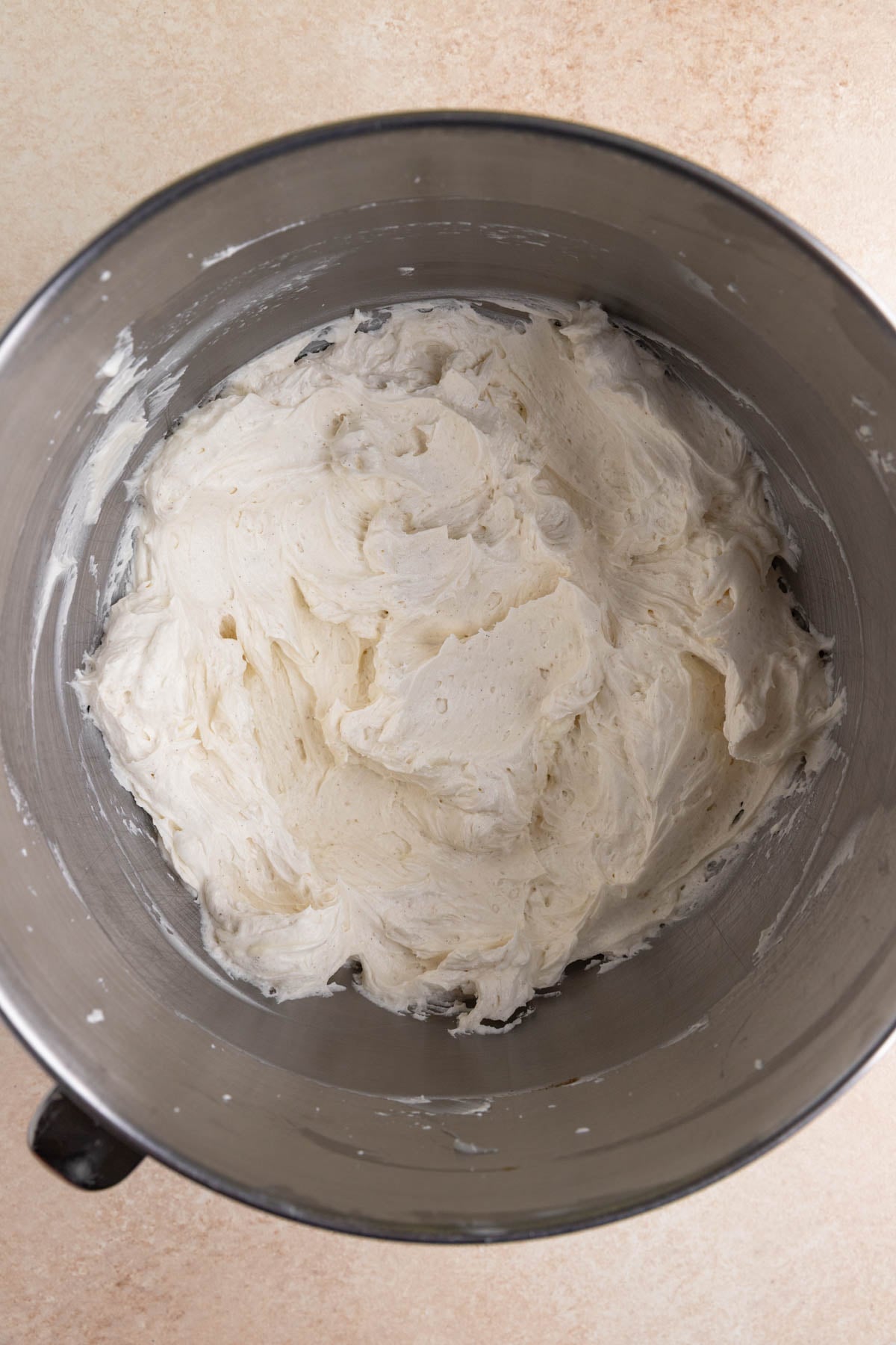 Whipped vanilla ermine frosting in a stainless steel bowl