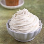 Piped vanilla ermine frosting in a white ceramic bowl