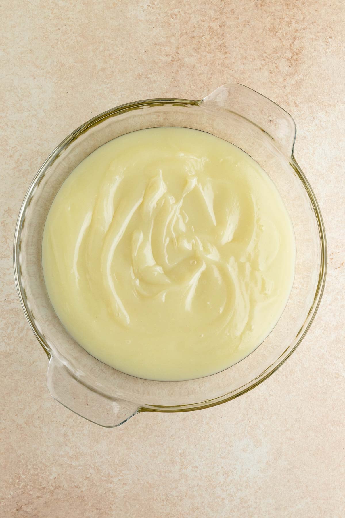 Cooked flour roux in a glass pie plate.