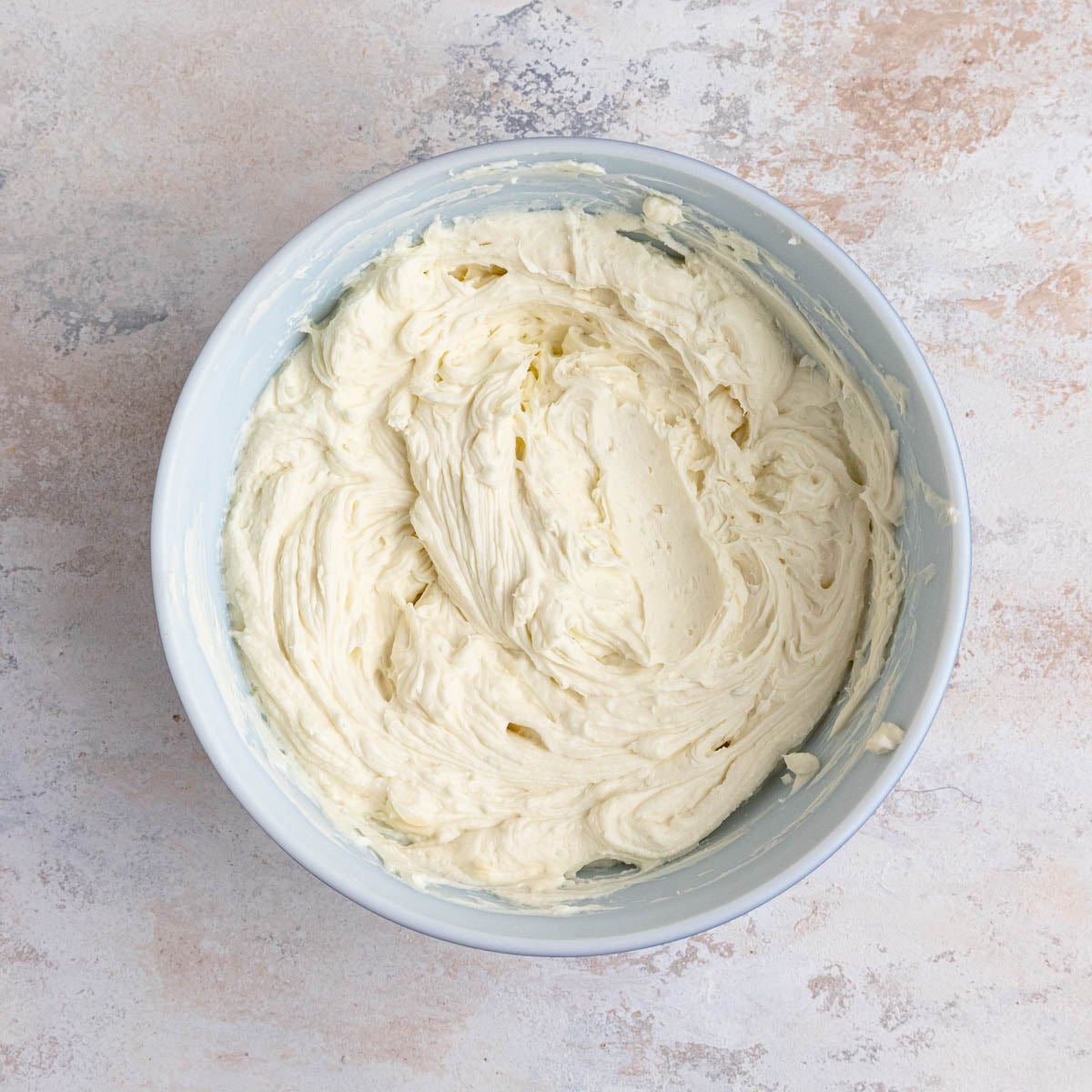 The whipped key lime cheesecake filling in a mixing bowl