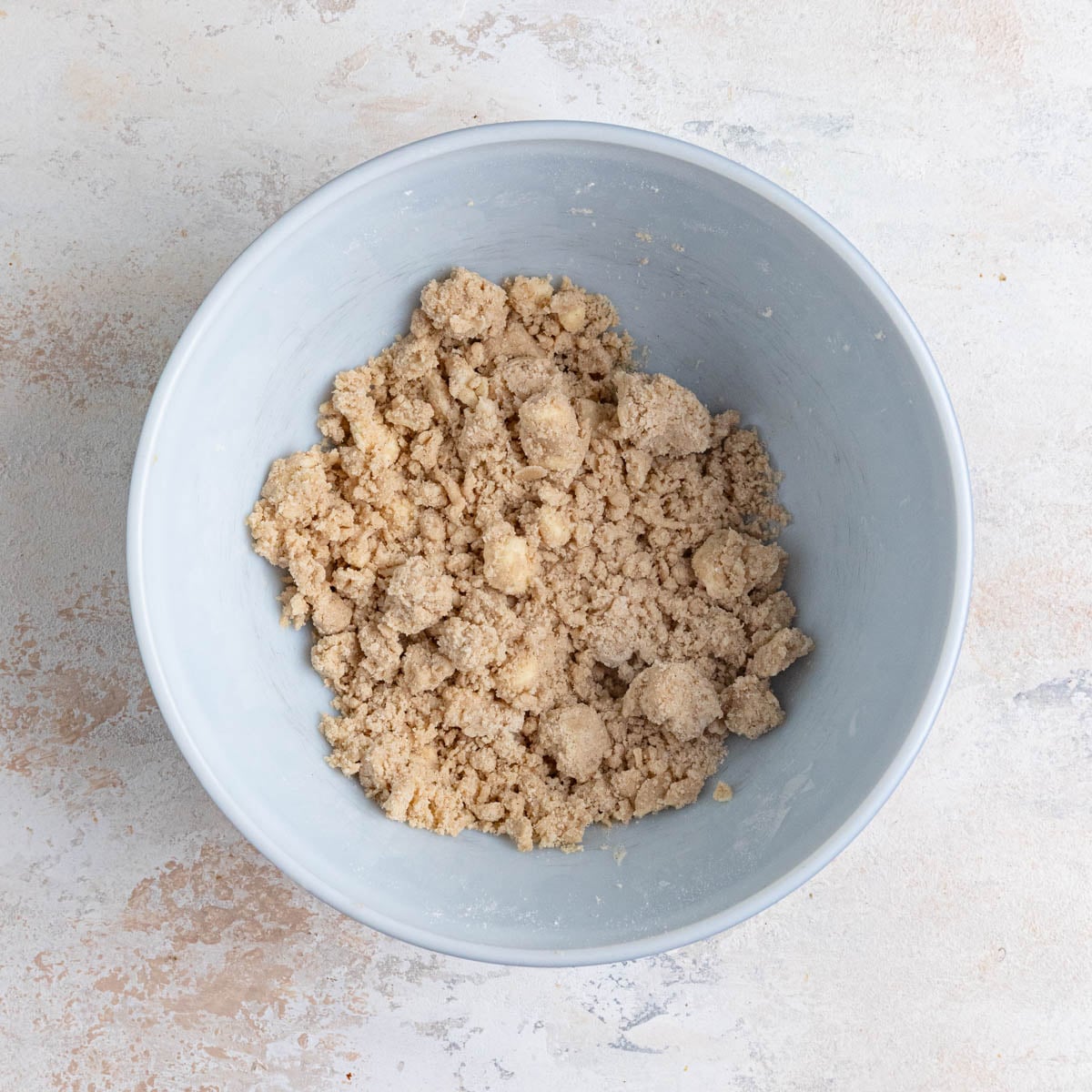 The crumble mixture in a large ceramic bowl