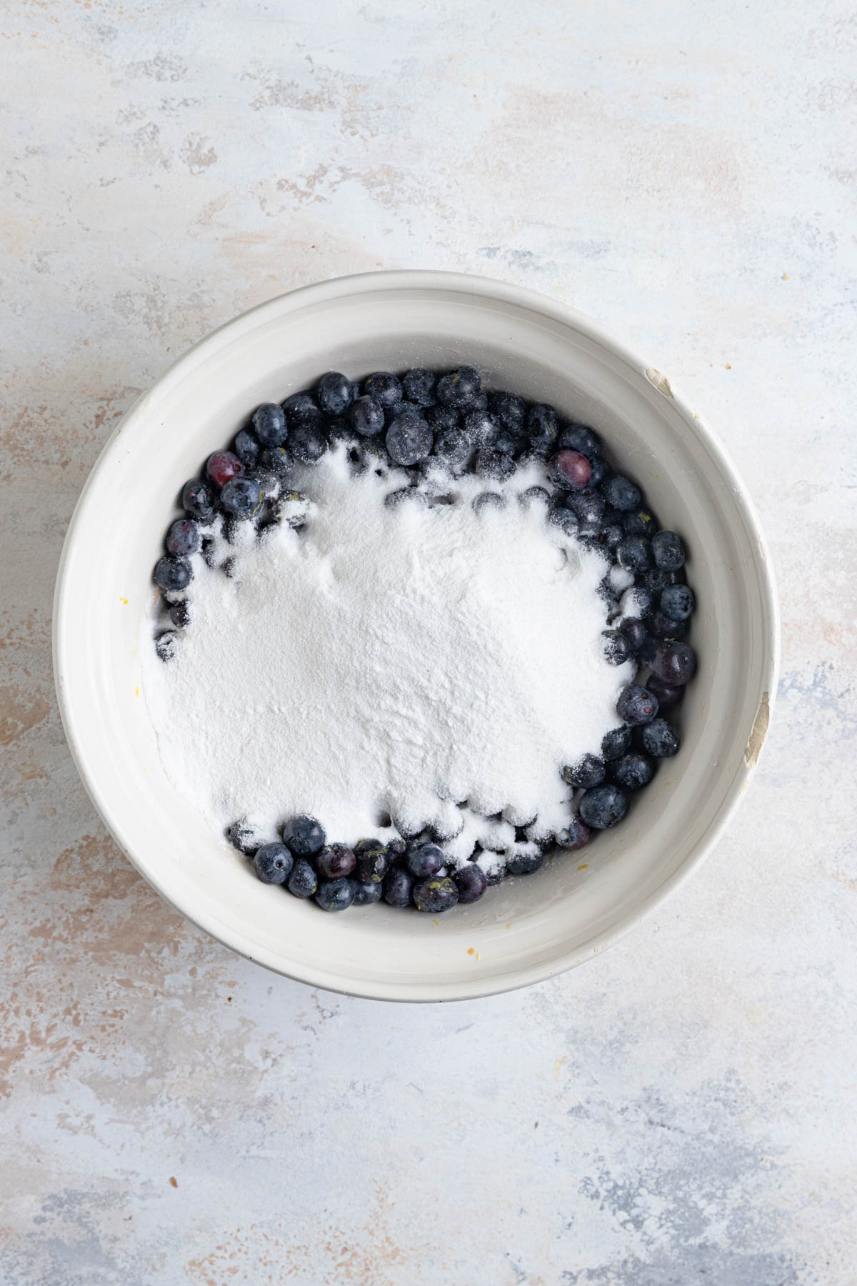Sugar and tapioca flour on top of the blueberries