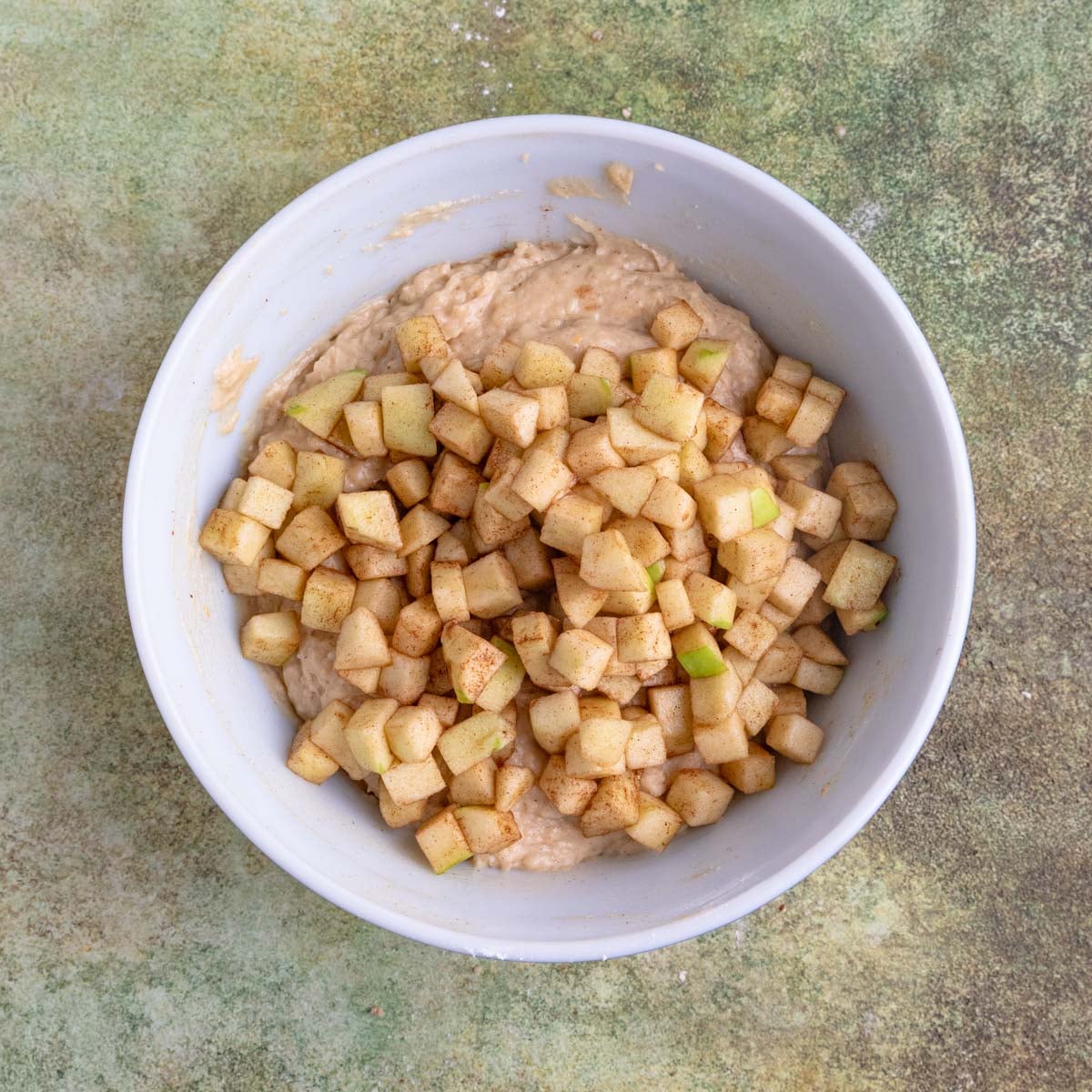 Muffin batter with the chopped apples added.